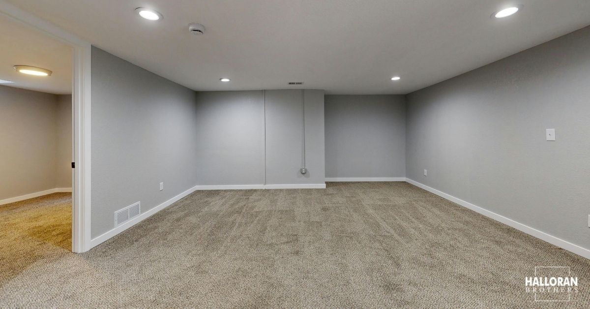 finished basement with carpet and light grey painted walls - Halloran Brothers basement remodel