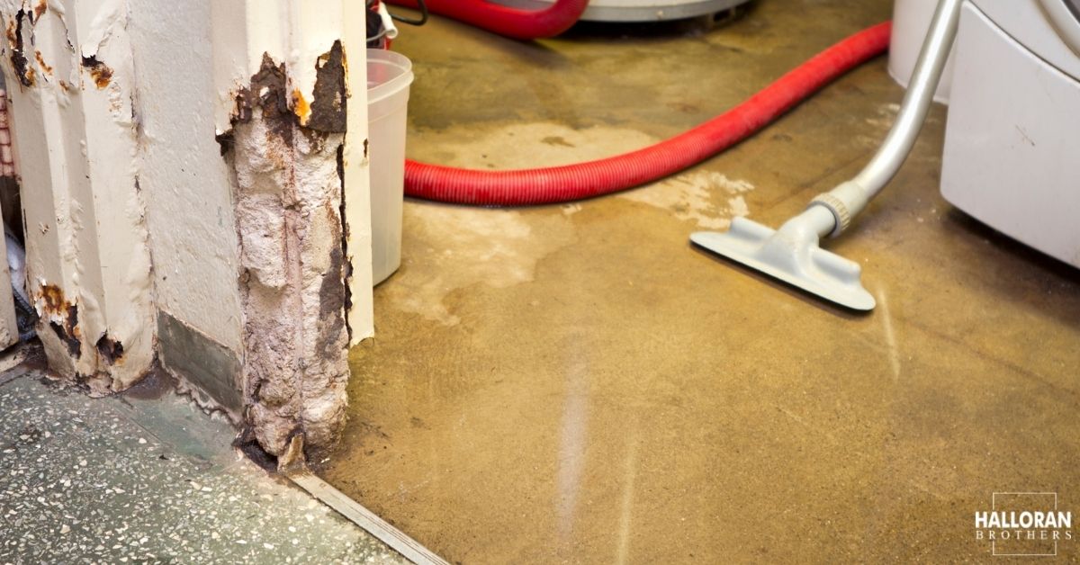 close up of a wall and floor with water damage stains - Halloran Brothers water damage insurance claim